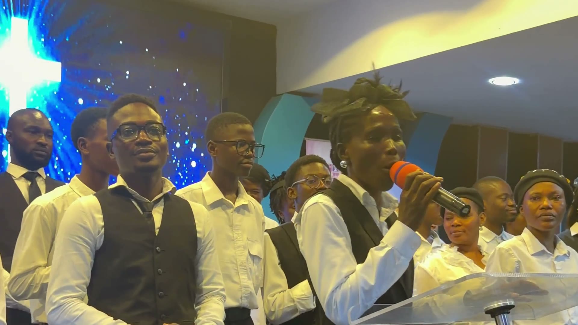 The choir beneath the cross and the congregation celebrating at Ilupeju Foursquare Gospel Church